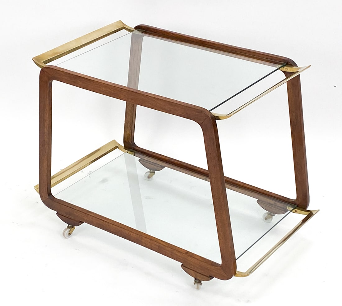 ATTR. OSWALD HAERDTL BAR CART: Modernist cart attributed to Oswald Haertdl. Walnut and brass. Austria, circa 1950's. Dimensions: H 23" x W 32" x D 17.75" Condition: Glass replaced. Light normal wear consistent with age and use.