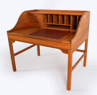 ATTR. ANDREAS HANSEN PINE WRITING DESK: Denmark, Circa 1990's. With leather top. Two-flip top compartments, and sliding door on top. Dimensions: H 40.75" x W 44"x D 32.25". Condition: Scatter nicks, scuffs and marks on top and edges. Blemis
