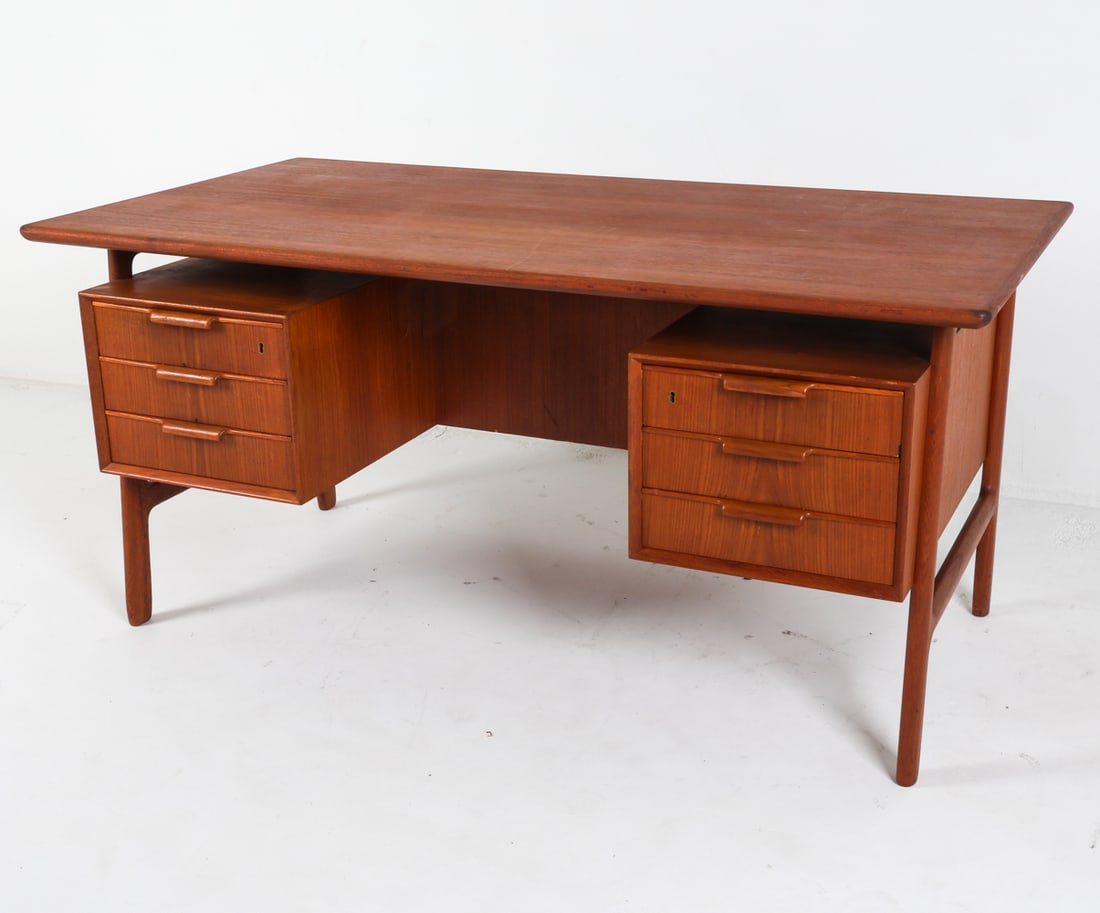 OMANN JUN MODEL NO.75 DANISH TEAK DESK: Labeled inside drawer. Circa 1960's. Dimensions: H 28.75" x W 60.25" x D 31.75". Conditions: No key. Light surface wear consistent with age and use, presents well overall. Per C190