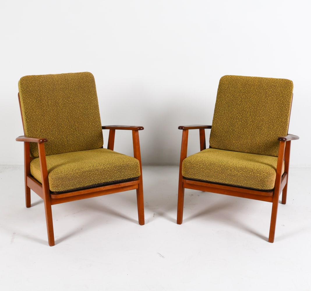 PAIR OF AAGE PEDERSEN STYLE TEAK LOUNGE CHAIRS: With wool upholstered cushions. Denmark, Circa 1970's. Dimensions: H 28.25"x W 26.5" x D 25.5 Seat height: 14" Condition: Slight musty odor to cushions. Moderate rubbing and scuffs on frames and arm r