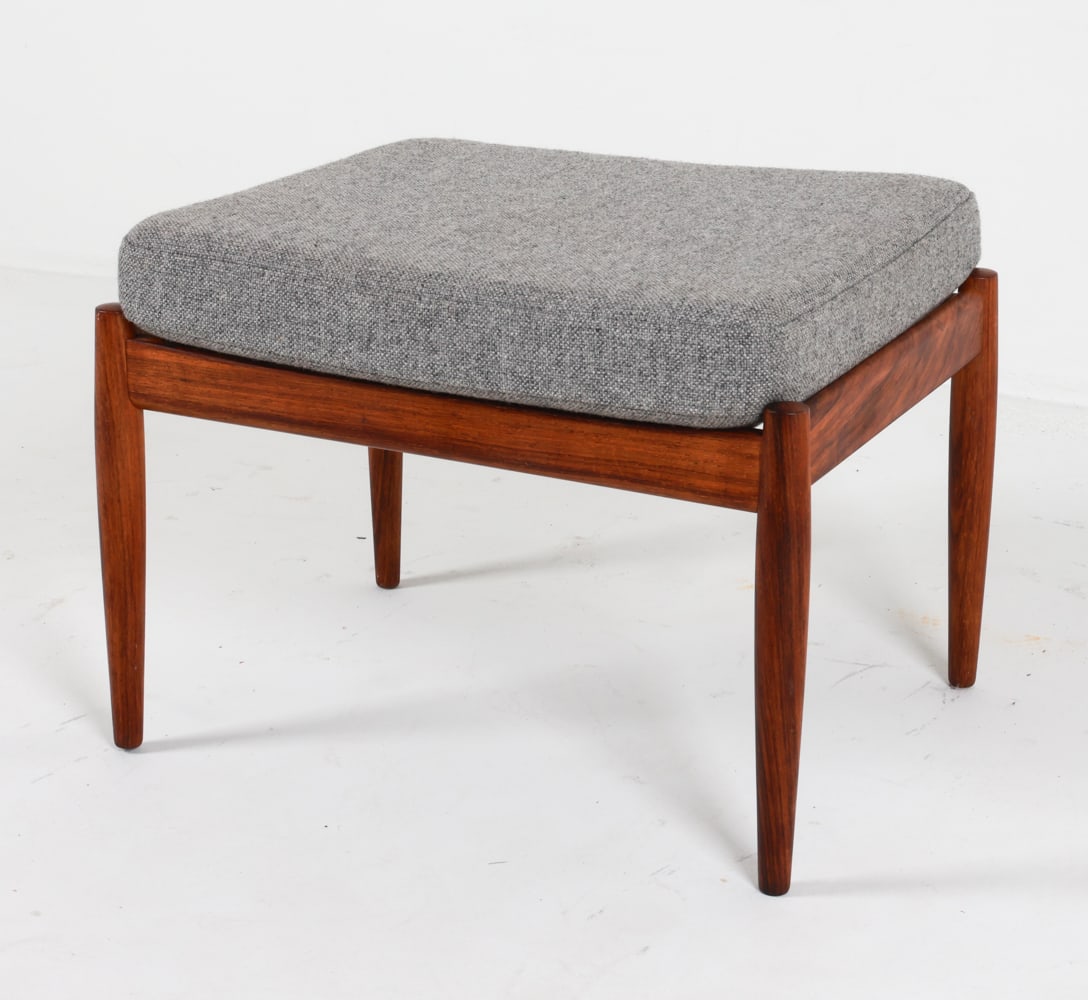 DANISH ROSEWOOD OTTOMAN C.1970'S: With wool cushion. Dimensions: H 16.25" x W 22.25" x D 18". Condition: Previous repair to base, a few faint dings and scuffs to legs. Wear consistent with age and use. PER C113