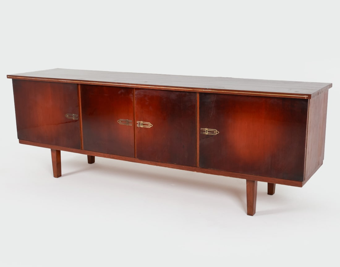 PRL MAHOGANY SIDEBOARD C.1970'S: Key included. Brass accents. Made in Poland.Dimensions: H 27.5" x W 79" x D 19".Condition: Few faint scuffs on top, old dings. One brass accent slightly bent. Previous repair to one cabinet door. Wear