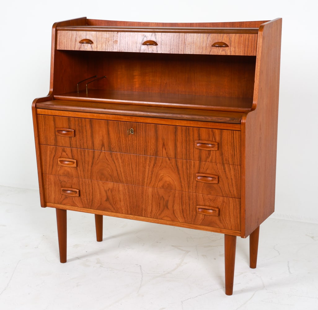 DANISH TEAK SECRETARY DESK C. 1960'S: Key included. Pull-out desk in center. Dimensions: H 41" x W 36.25" x D 16.25". Full Desk D 13.5". Condition: Water ring on pull-out desk. Wear consistent with age and use.
