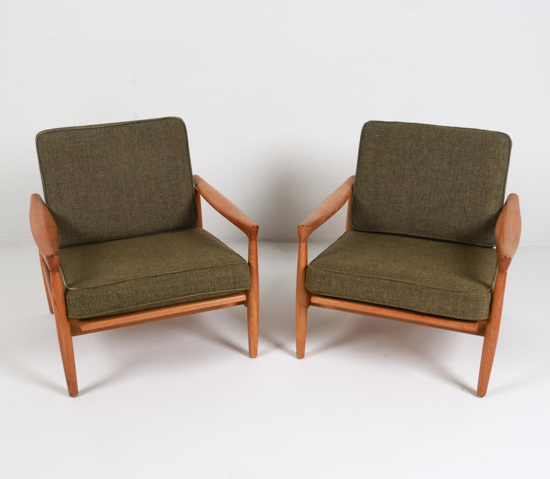 PAIR ERIK WOERTS "KOLDING" OAK LOUNGE CHAIRS: Designed by Erik Woerts, model "Kolding". Green wool cushions. Danish, circa 1960's.Dimensions: H 27" x W 28" x D 26" x SH 15".Condition: Few water spots to wood on arms, legs. Scattered scuffs and ol