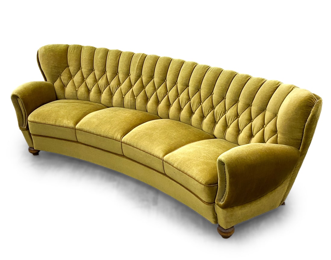 DUTCH MOHAIR BANANA SOFA C. 1960'S: Light green tone mohair. Tufted back. Curve form. Tacks to edges and sides of upholstery. Dimensions: H 33" x W 100" x D 32" Seat height: 17" Condition: Moderate discoloration of upholstery to arm res