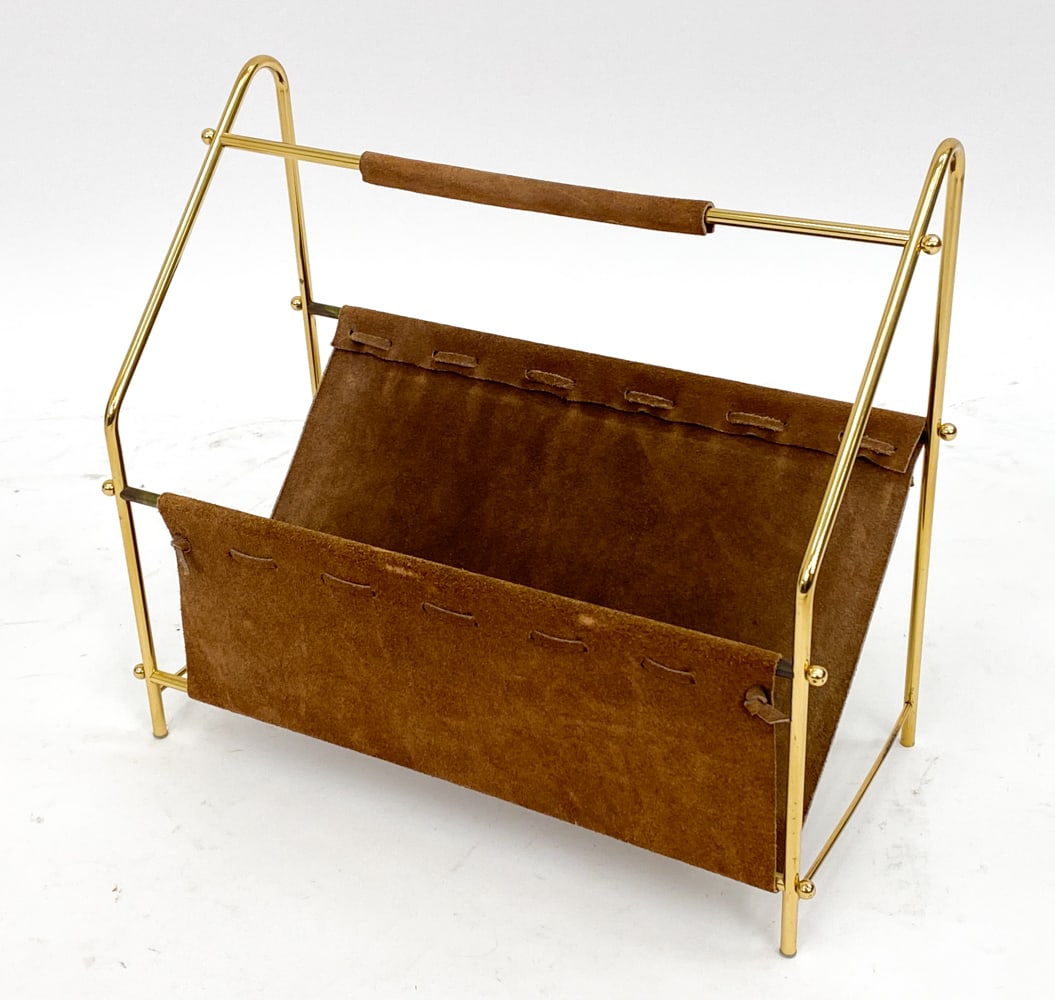 DANISH BRASS & LEATHER MAGAZINE RACK C. 1970'S: Suede leather. Brass frame. Dimensions: H 15" x W 17" x D 7.75" Condition: Slight scuffs to leather on edges. Tarnishing to brass. Wear consistent with age and use. PK039
