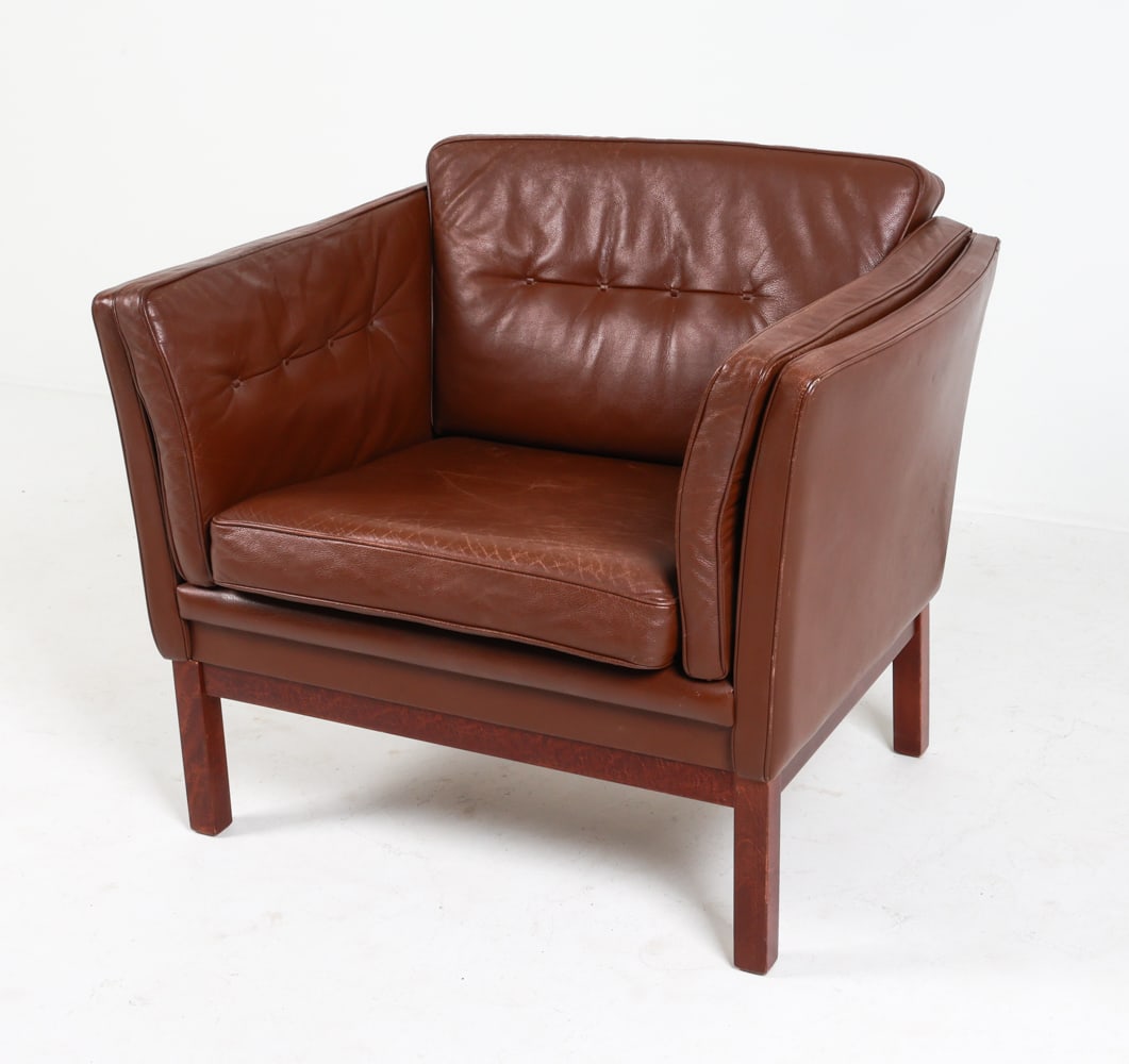 SKIPPERS DANISH LEATHER LOUNGE CHAIR: Beech legs. Circa 1970's. Dimensions: H 31" x W 36" x D 30" x SH 15". Condition: Some wear to leather, slight drying and scratches. Small patch to back corner seam. Wear consistent with age and use. C