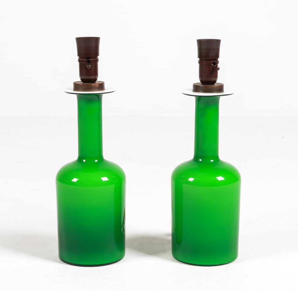 PAIR OF OTTO BRAUER GLASS VASE LAMPS C. 1970'S: For Holmegaard. Vases modified into lamps. Denmark. Dimensions: H 15.75" x Dia. 5". Condition: Minor scuffs on underside. No shades. With European plug. Untested. Wear consistent with age and use.
