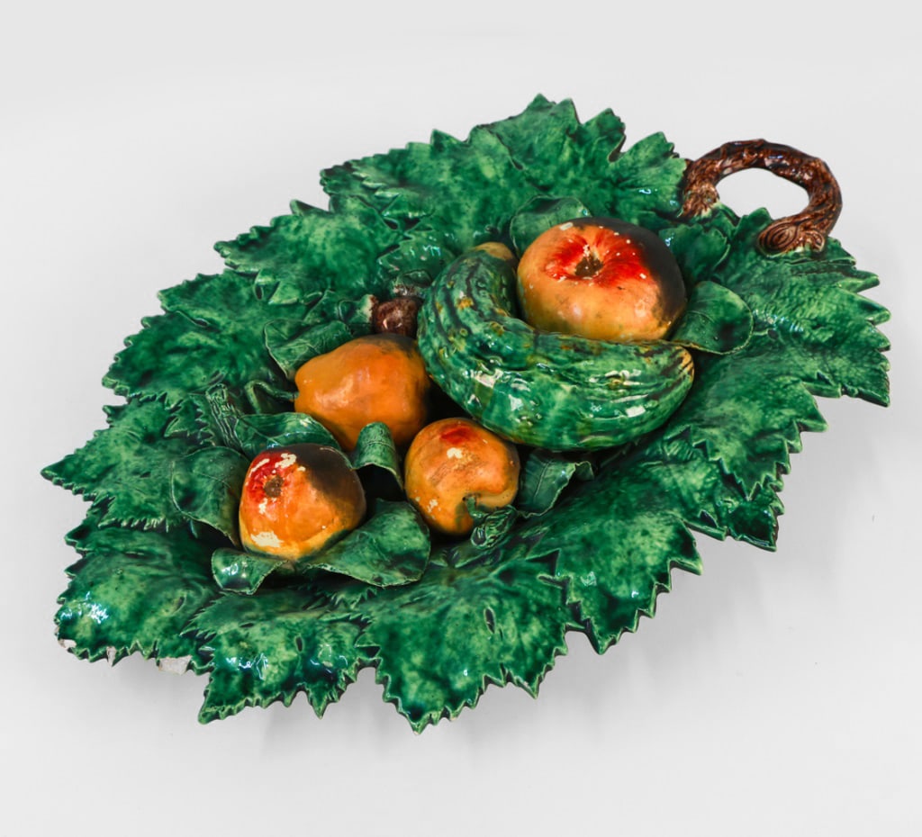 PORTUGUESE MAJOLICA WALL PLATTER: Wirth wall hanging hardware. Stamped to underside, Indistinctly, Marked Portugal. Dimensions: H 4" x W 18.75" x D 14" Condition: Moderate losses to plaint on plaster. Nicks and scuffs. Crazing to cera