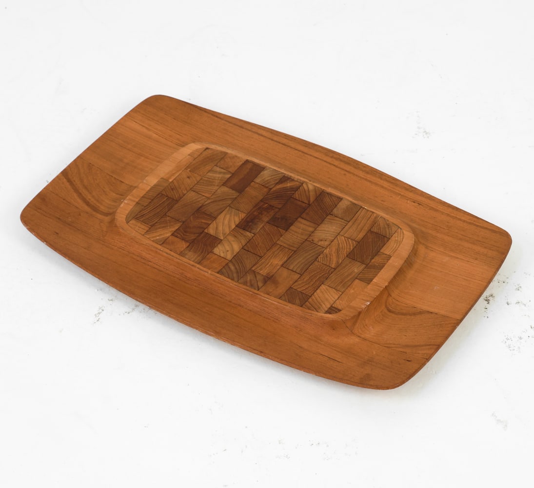 JENS QUISTGAARD DANISH TEAK CHARCUTERIE BOARD: Stamped to underside. Dimensions: L 19" x W 12" Condition: Moderate scuffs and marks on center. Rubbing on edges. Wear consistent with age and use.