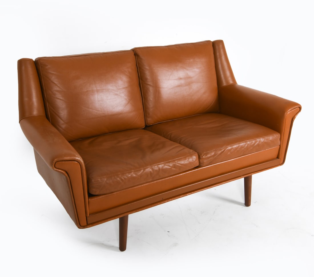 DANISH COGNAC LEATHER LOVESEAT SOFA C. 1960'S: With tapered teak legs. Dimensions: H 31" x W 49" x D 30" x SH 16.5". Condition: Some rubs to leather along edges, back, arms. Few scratches to leather and legs. Wear consistent with age and use. DMM1