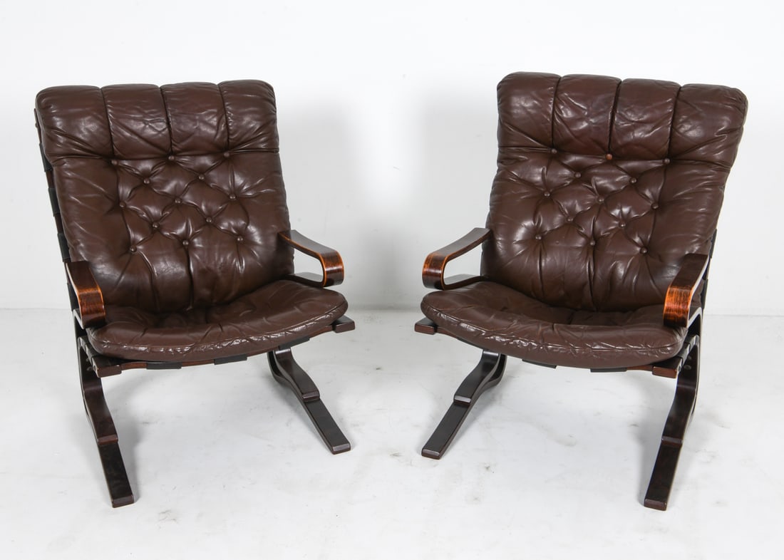 PAIR OF ODDVIN RYKKEN LEATHER LOUNGE CHAIRS: Beech bentwood frames with tufted brown leather upholstery. Norway, circa 1960's. Dimensions: H 38" x W 26" x D 31" x SH 18". Condition: Rubs and scuffs to wood, mostly along edges. Light scuffs to le