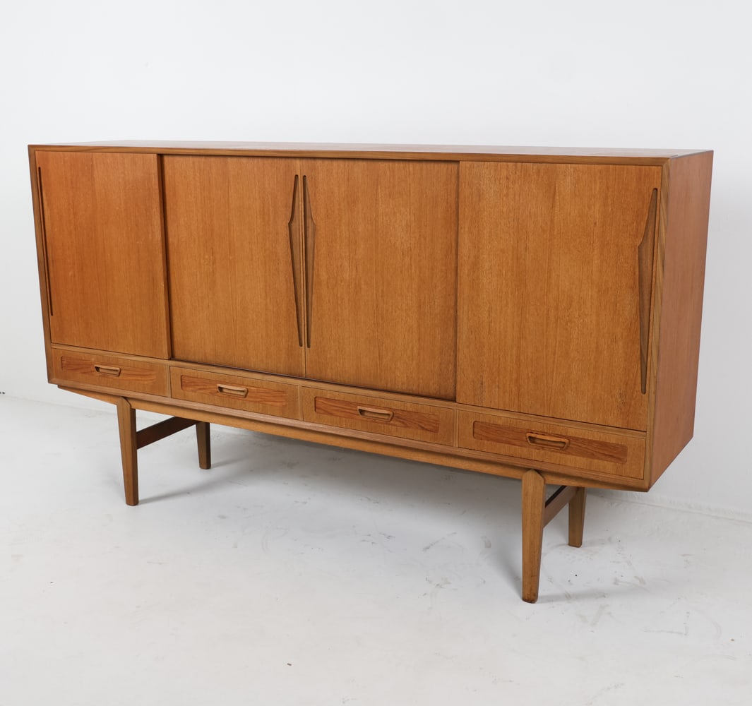MID-CENTURY DANISH TEAK SIDEBAORD C. 1960'S: With Carved recessed door handles. With adjustable inner shelves. Proper left cabinet reveals etched inner glass panels with velvet lined drawers. Dimensions: H 45.5" x W 78.75" x D 17.75" Condition:
