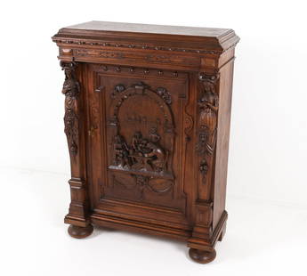 DANISH ANTIQUE BAROQUE REVIVAL OAK CABINET: With Key. Cabinet door with raised profile depicting a scene of men in a pub, with comedy masks above them. Sides are flanked with carved columns with designs of women, one with a book the other with