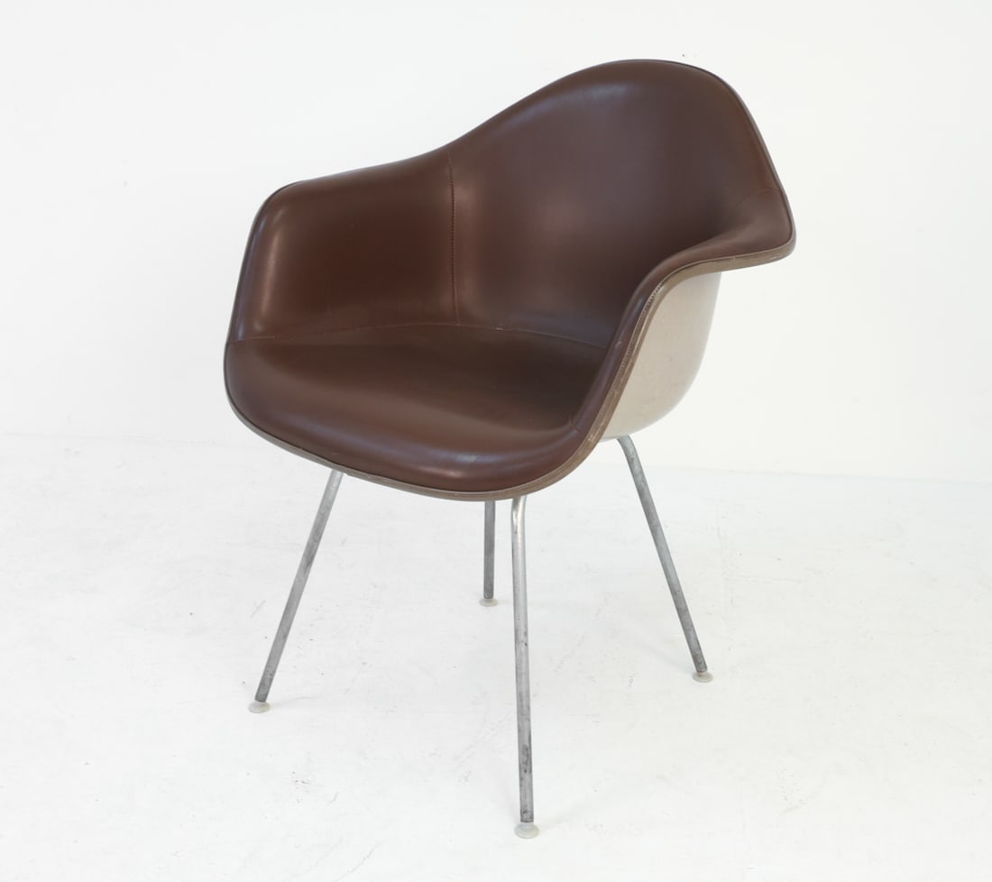 EAMES HERMAN MILLER DAX CHAIR C. 1960'S: Molded plastic seat wrapped in tan leather upholstery. Dimensions: H 32" x W 25.5" x D 26" x SH 17.25". Condition: Few scratches and indents to leather. Wear consistent with age and use.