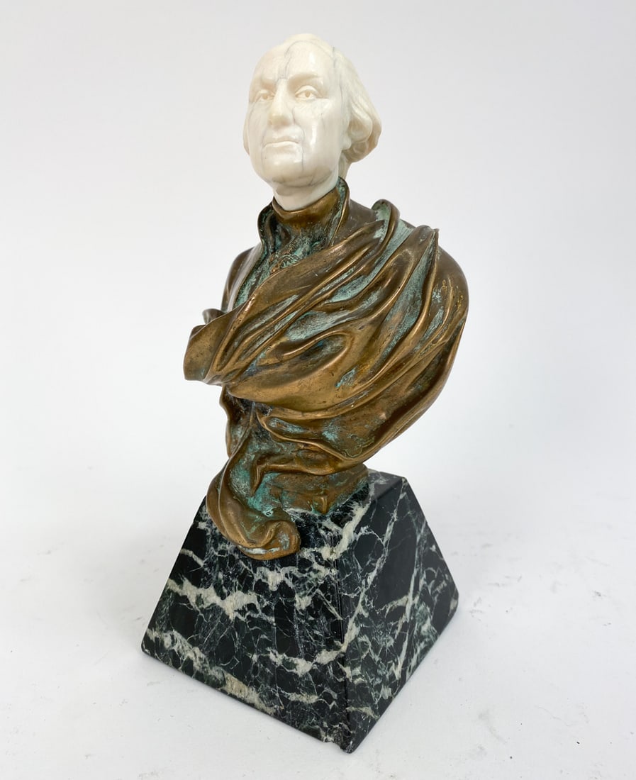 ANTIQUE GEORGE WASHINGTON BRONZE BUST: Bust of George Washington with a marble base, bronze torso, and bone head. Unsigned. Dimensions: H 7.25" x W 4" x D 3.25" Condition: Some patina and oxidation to bronze. Marble with a few small chips.