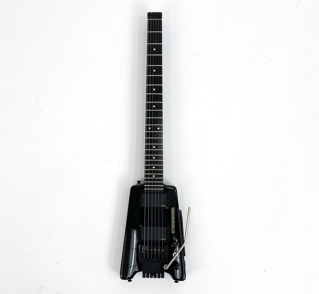 STEINBERGER GL2S HEADLESS ELECTRIC GUITAR: #N000489, c. 1990s. Black gloss finish with black hardware. Boat oar shaped body and richlite fingerboard with white dot inlay markings. With EMG pickups. Made in USA.Condition: Very clean, Very minor