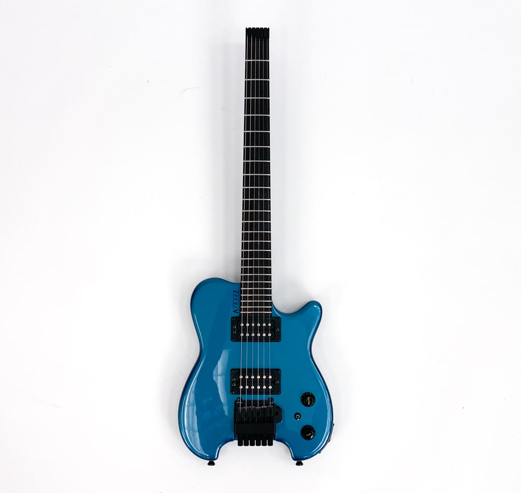KIESEL HEADLESS ELECTRIC GUITAR MIRROR BLUE: c. 2017-2023. USA made. Mirror blue finish to body with all black hardware. Ebony fingerboard with white dot marker inlays on the side. Backplate included. Condition: Very good condition. Showing norm