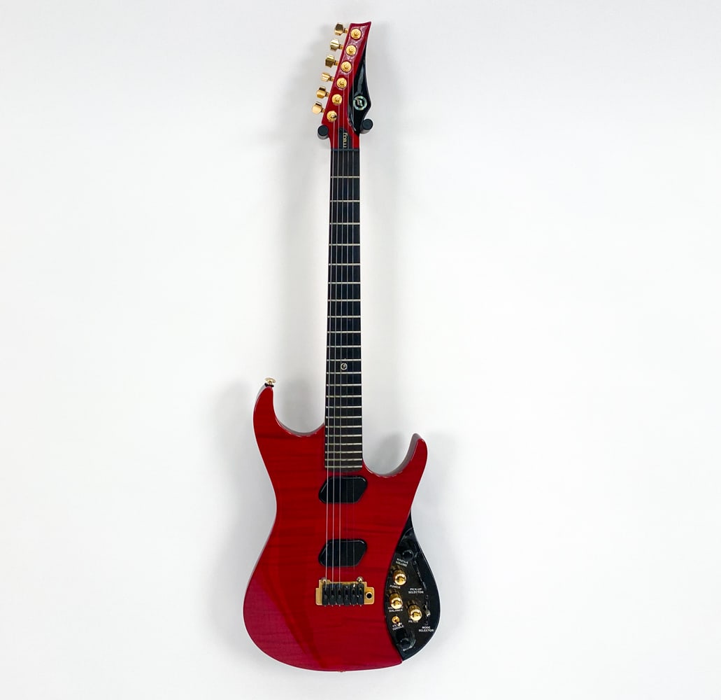 MOOG E1 RED PAUL VO ELECTRIC GUITAR 2008: Signed Paul Vo collector edition, #GKB 0185, c.2008-2009. Red gloss tiger stripe finish with gold/black hardware. Ebony fingerboard with abalone inlay. Comes in tweed Moog case. Includes Moog expressi