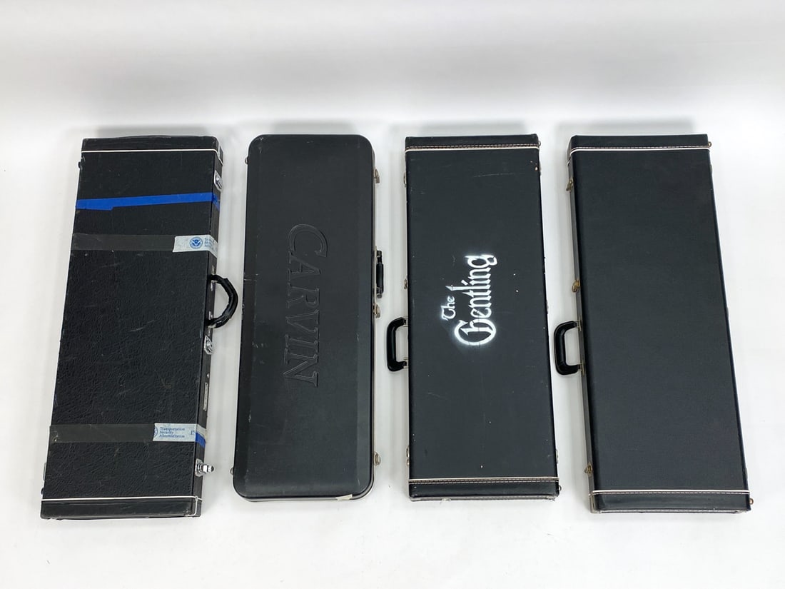 (4) GUITAR HARDCASES: Including Moog and Caravin guitar protective hardcases. Condition: Showing wear consistent with use including Moog with tape and tape residue on the outside (Upper portion of hinges are detached). One