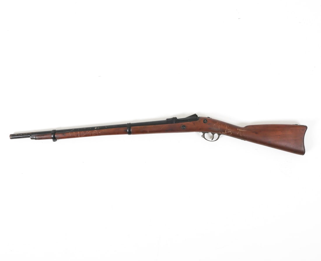 SPRINGFIELD TRAPDOOR RIFLE MODEL 1873: Marked "Springfield" on the side. Constructed from iron and wood. The Springfield Model 1873 was the first standard-issue breech-loading rifle adopted by the United States Army. Dimensions: H 4.5" x L