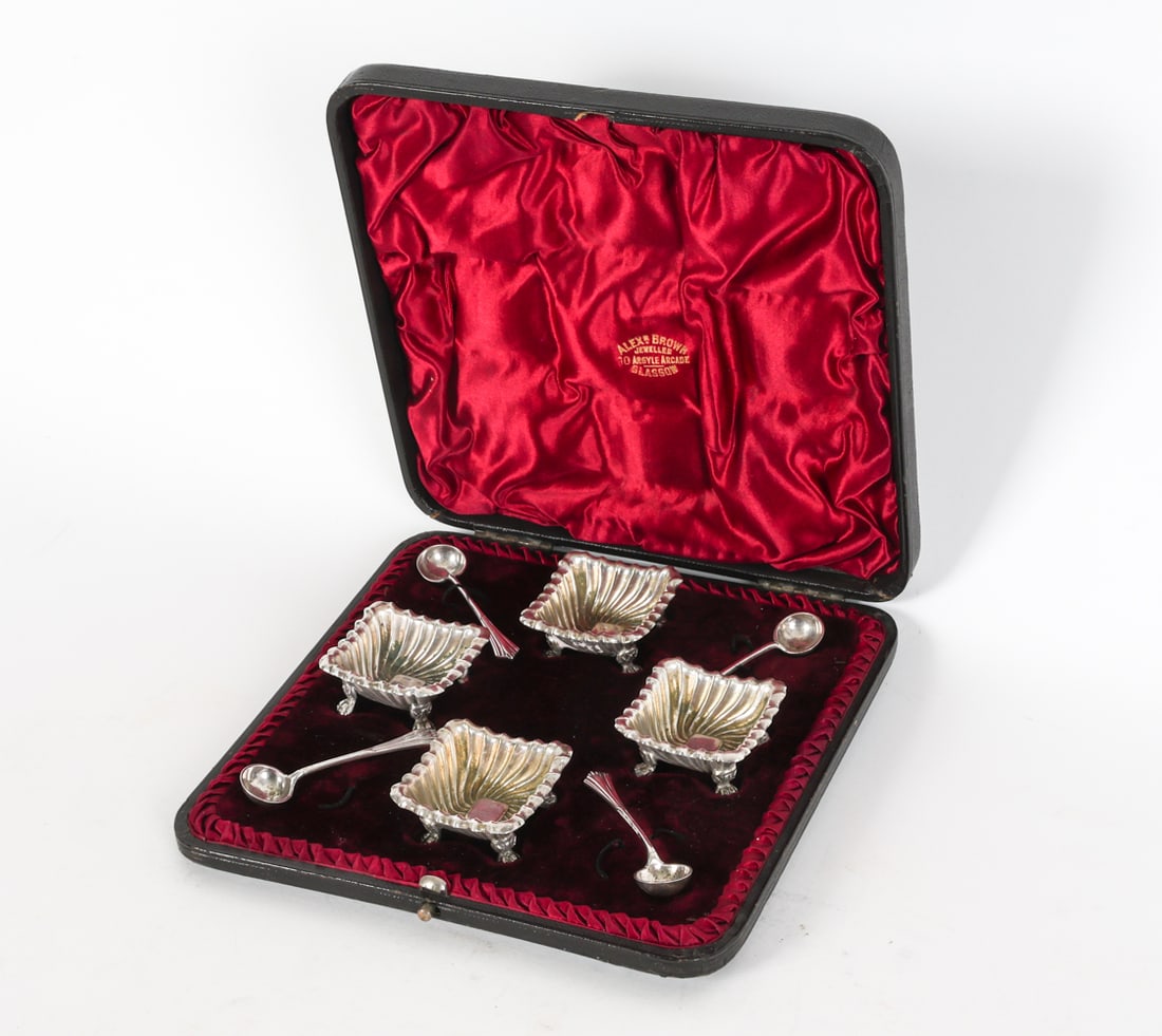 ANTIQUE ALEX BROWN SCOTTISH SILVER SALT CELLARS: A set of four antique silver salt cellars with matching spoons by Alex Brown, housed in original leather and velvet-lined box. Total Weight: 3.67 ozt. Dimensions: (box) H 1.25"x W 7.25" x D 7.25". Con