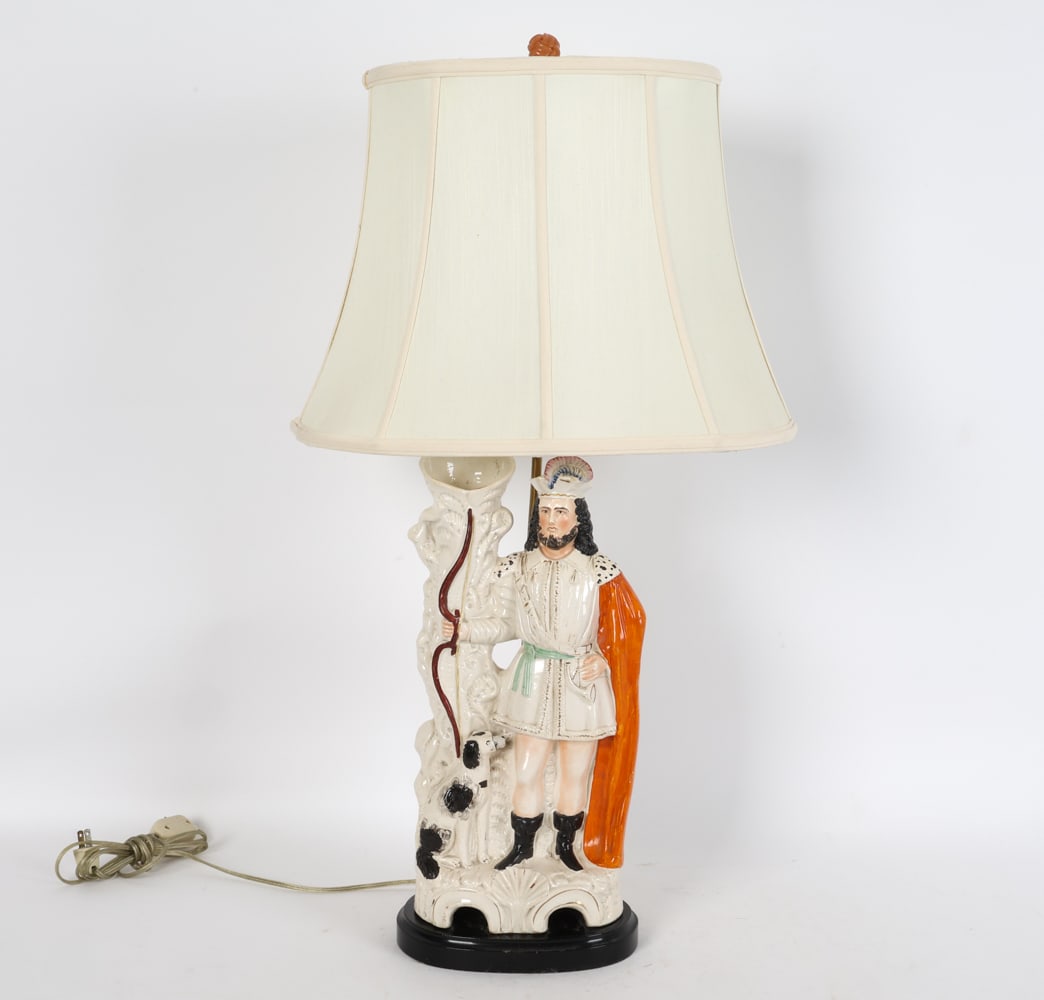 ANTIQUE STAFFORDSHIRE POTTERY HUNTER FIGURE LAMP: Converted into a lamp with wooden base. Dimensions: w/o shade H 23" x W 8.5" x D 7.75". Condition: Minor loss to dog's face. Some hairlines. Rubbing to finish. Wear consistent with age and use.
