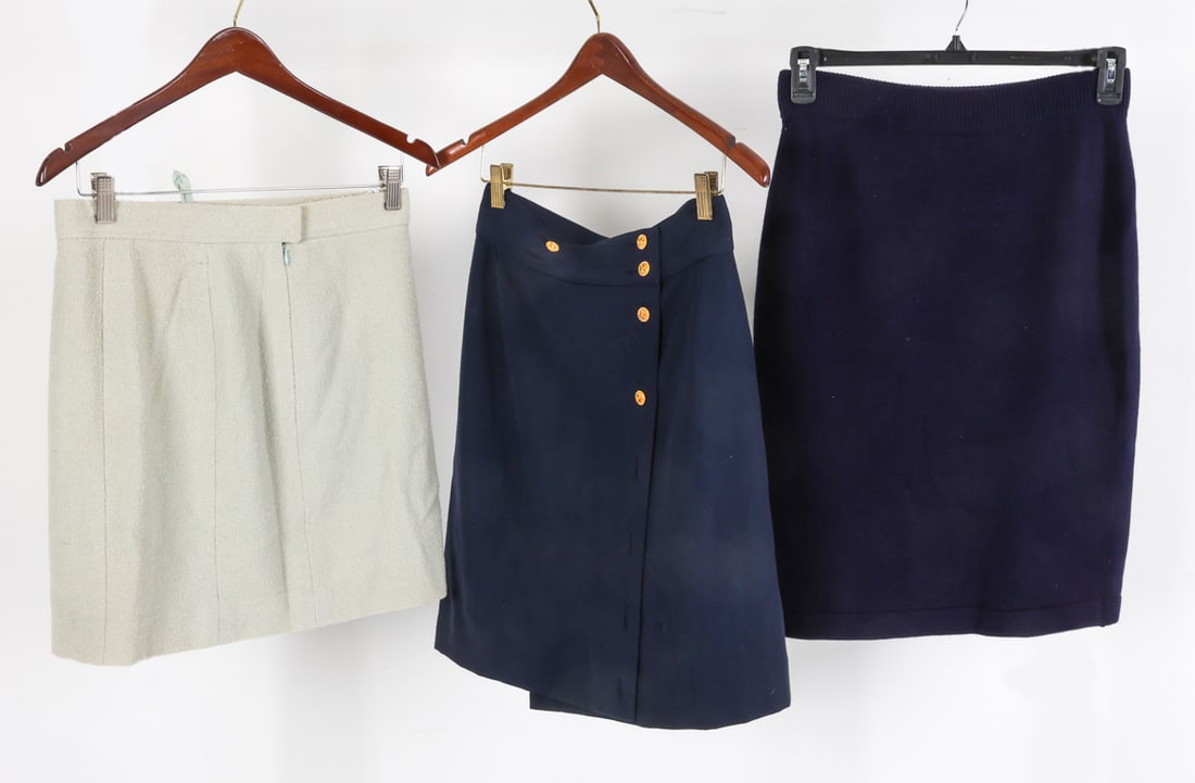 VINTAGE CHANEL SKIRT GROUPING: Dimensions: Blue Wool L 23.5" x Waist 14.5". Blue / Buttons L 21" x Waist W 13.5". Light Blue L 17.5" x Waist W 14.25". Condition: Missing buttons to one skirt. Wear consistent with age and use.