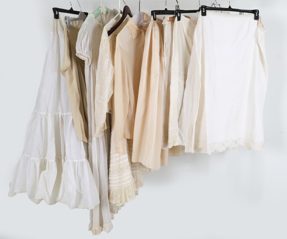 VINTAGE WOMENS UNDERSHIRT, SKIRT, & DRESS GROUPING: Grouping of white underclothing ranging from shirts, skirts, and slips. White and cream. Dimensions: Largest Skirt L 45". Condition: Some discoloration to fabric. Wear consistent with age and use.