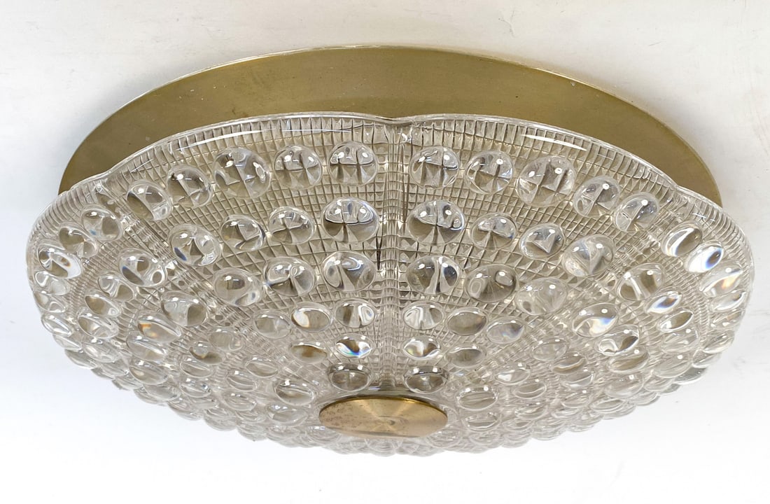 CARL FAGERLUND FOR ORREFORS CRYSTAL & BRASS LIGHT: Textured convex crystal. Danish, Circa 1960s. Dimensions: H 4" x Dia 16". Condition: Crystal presents well overall. Marks and scuffs on brass. Untested. Wear consistent with age and use.
