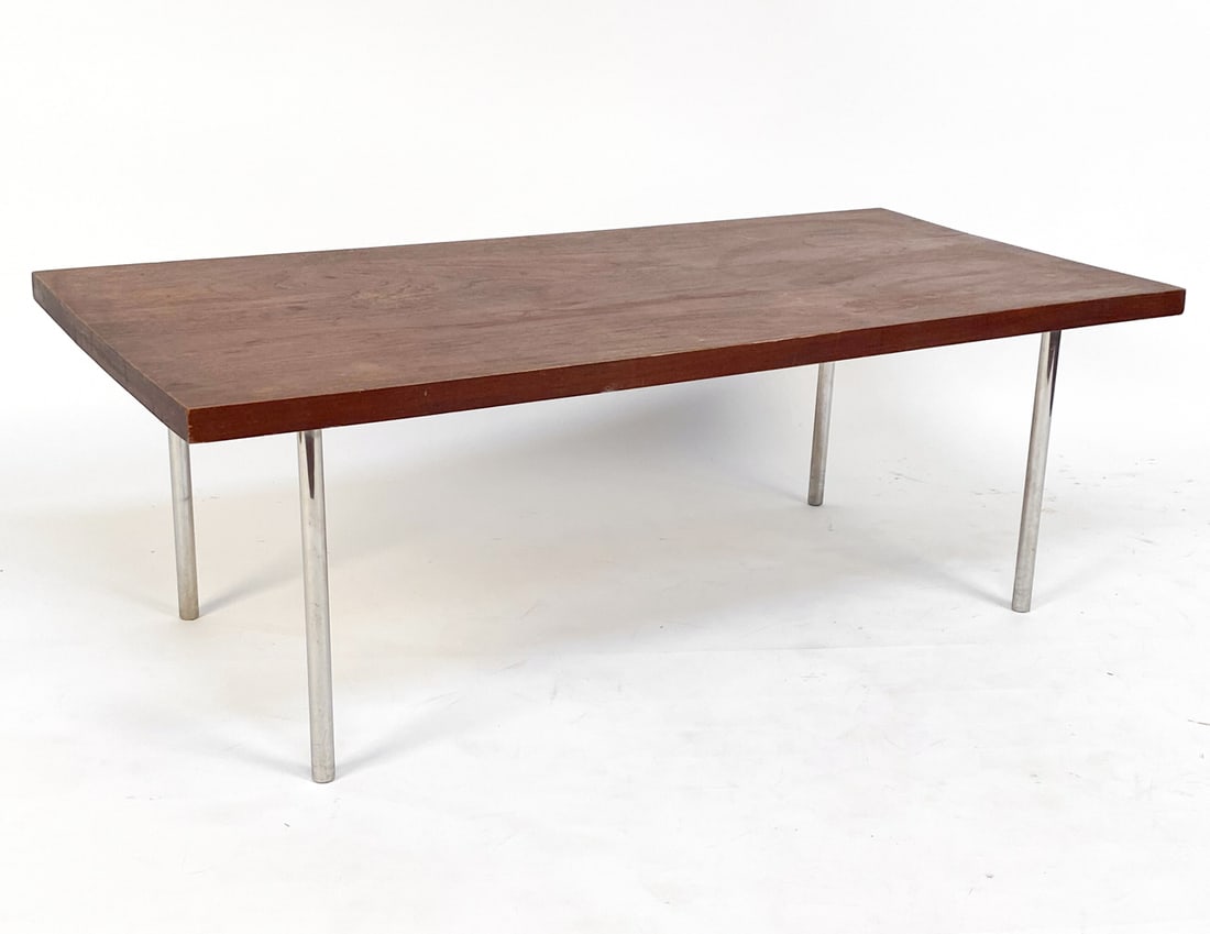 MID-CENTURY TEAK AND CHROME COFFEE TABLE: Dimensions: H 16" x W 46" x D 22.25". Condition: Scuffs and marks to surface. Some fading and discoloration to top. Slight marks on steel.