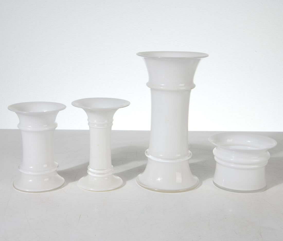 HOLMEGAARD ROYAL COPENHAGEN GLASS VASE GROUP: (4) glass vases. Tags on sides. Dimensions: Tallest H 9" x Dia. 4.5". Condition: Few rubs on edges. Small faint scuffs of discoloration. DMM154