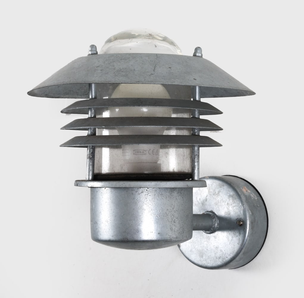 NORDLUX 'VEJERS' GALVANIZED STEEL WALL SCONCE: Danish, Circa 1960's Dimensions: H 9" x Dia 8.25" x W 11" Condition: Minor scuffs and slight marks on steel. Untested. Wear consistent with age and use. DML174