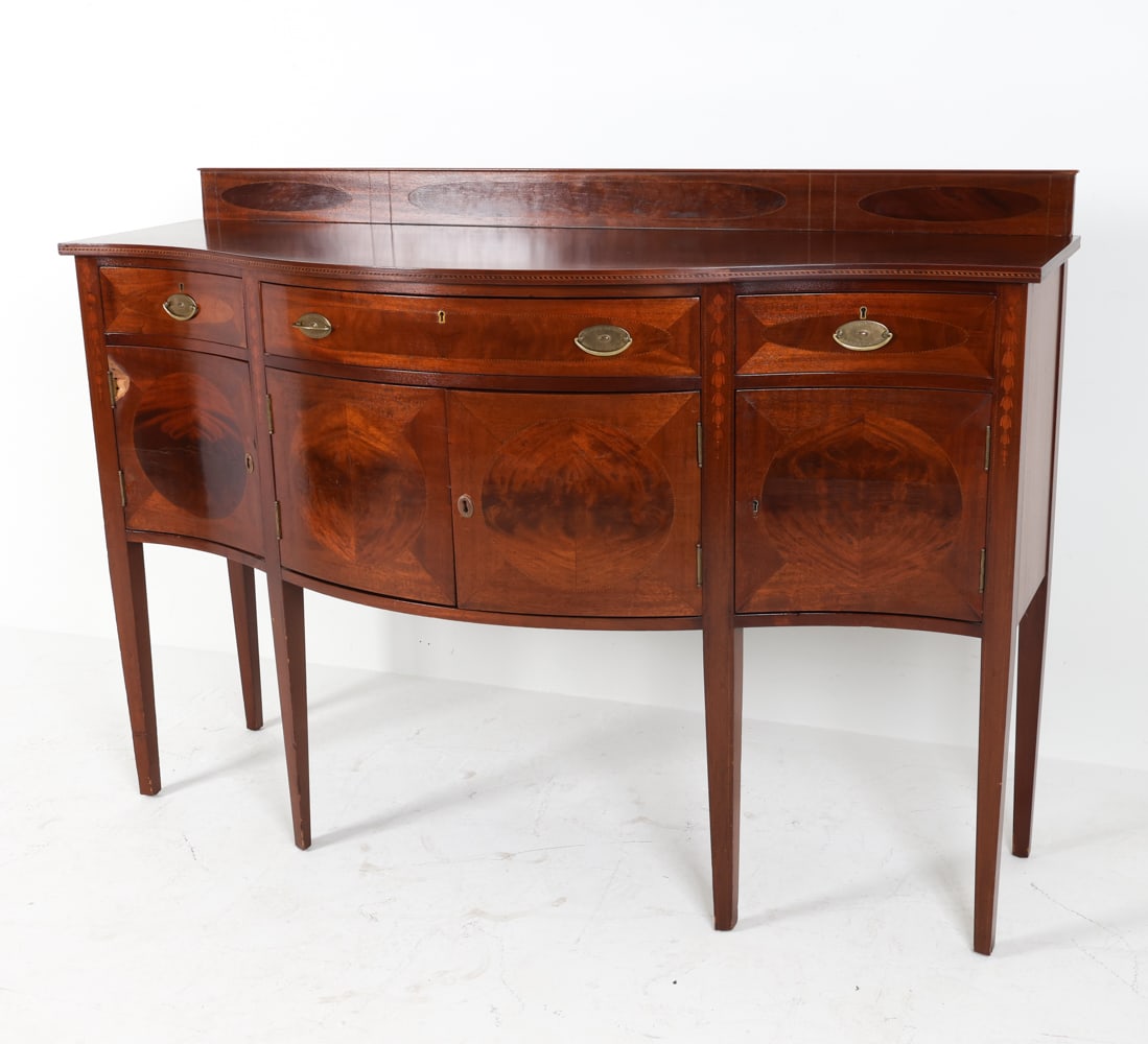 FEDERAL STYLE MAHOGANY SIDEBOARD: Brass hardware. Wood inlaid border. Dimensions: H 41" x W 64" x D 22.5". Condition: Key included. losses to cabinet door front. Light surface scratches to top. Some stress cracks to cabinet doors. Wea