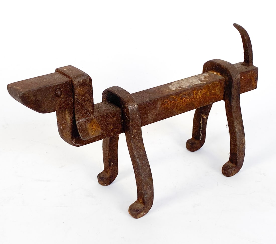 ANTIQUE IRON DASCHUND FIRE DOG OR DOOR STOP: In the form of a dog Dimensions: H 7.25" x W 4'x D 13.5 Condition: Oxidation to iron. Nicks and blemishes. Wear consistent with age and use.