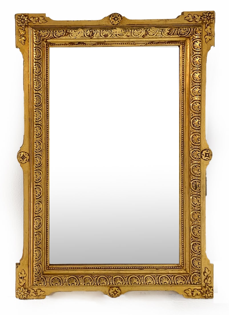 FRENCH GILT CARVED WOOD WALL MIRROR: Gilt wall mirror with wood ormolu designs to edges and corners. Dimensions: H 50.75"x W 35" Condition: Moderate nicks, scuffs and rubbing of gold leaf on edges. Wear consistent with age and use.