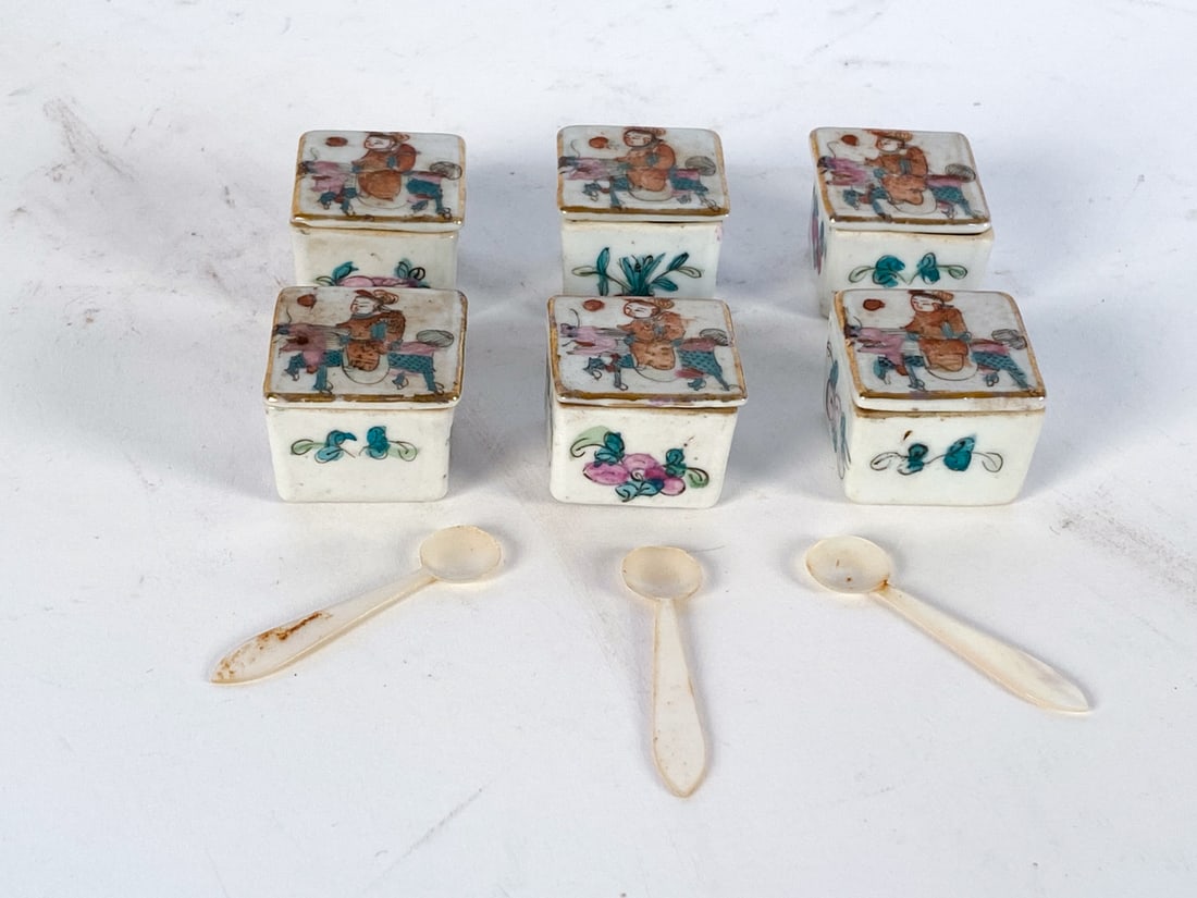 ANTIQUE CHINESE PORCELAIN SALT CELLAR GROUPING: (6) salt cellars and 3 mother of pearl spoons. Dimensions: H 0.75" x W 1" x D 1". Condition: Minor surface soiling on lids. Rubbing to gilt rims and scuffs throughout. Wear consistent with age and use