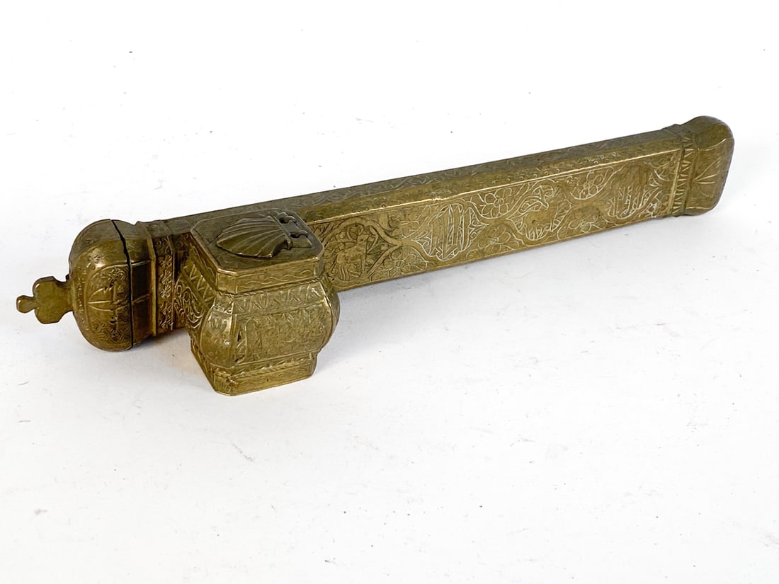 ANTIQUE PERSIAN BRASS INKWELL PEN CASE: Intricate etchings of floral and animal designs. Dimensions: H 1.75" x W 2" x D 10.25" Condition: Minor indenting of brass on edges. Tarnishing to heavily used areas. Wear consistent with age and use.