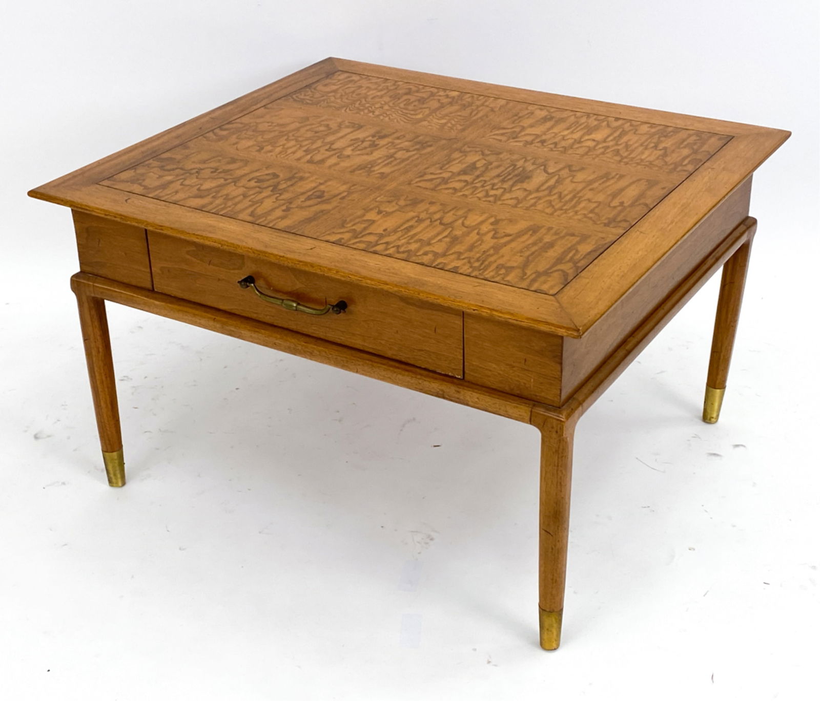 TOMLINSON SOPHISTICATE COFFEE OR END TABLE: Wooden end table with one drawer and brass feet. Retailed by Vanleigh, New York, labels inside drawer. Dimensions: H 19" x W 32" x D 28" Condition: Few surface marks consistent with age and use includ