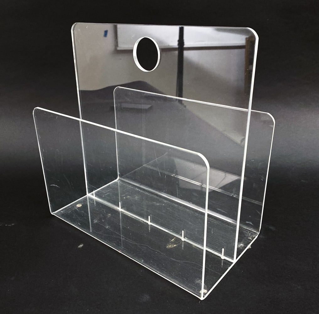 DANISH ACRYLIC MAGAZINE RACK C. 1980'S: Dimensions: H 13.5"x W 13" x D 7.75" Condition: Scattered scuffs and marks to acrylic. Wear consistent with age and use. PK059