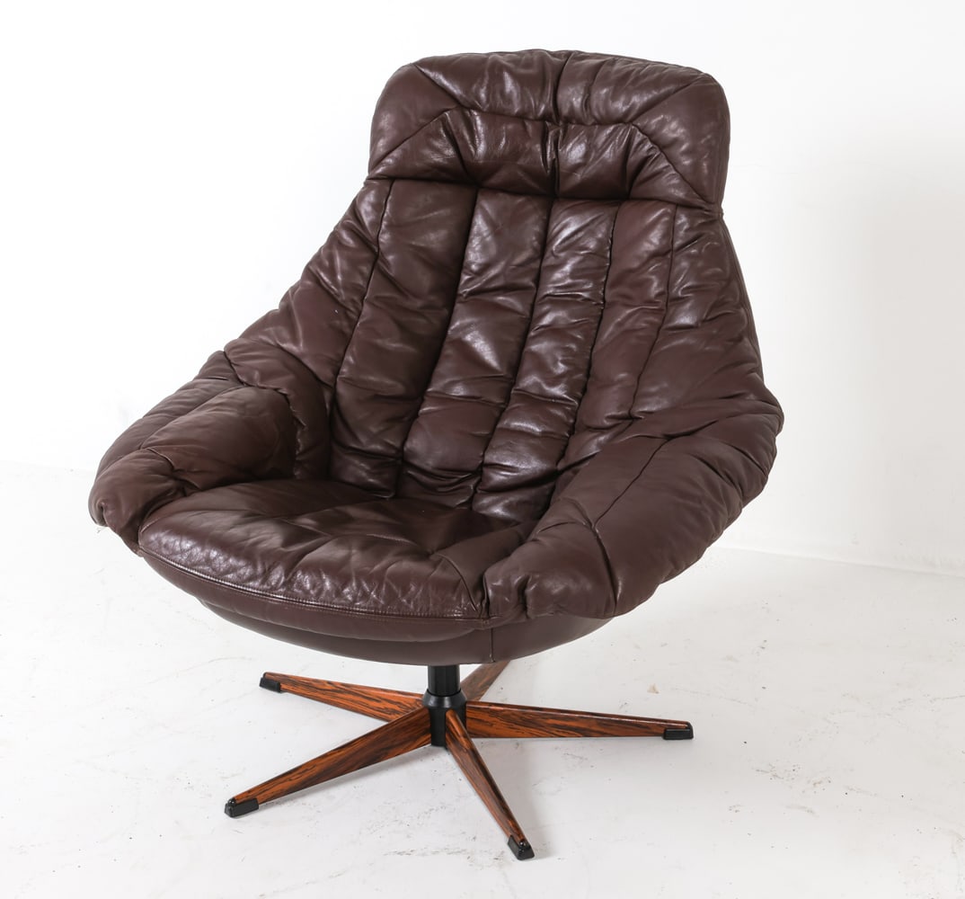 H. W. KLEIN DANISH LEATHER SWIVEL 'EGG' CHAIR: Rosewood veneer on swivel base. Denmark, circa 1960s. Dimensions: H 36" x W 32" x D 28.5" x SH 15.75". Condition: Minor scuffs to leather. Wear consistent with age and use. DMN063