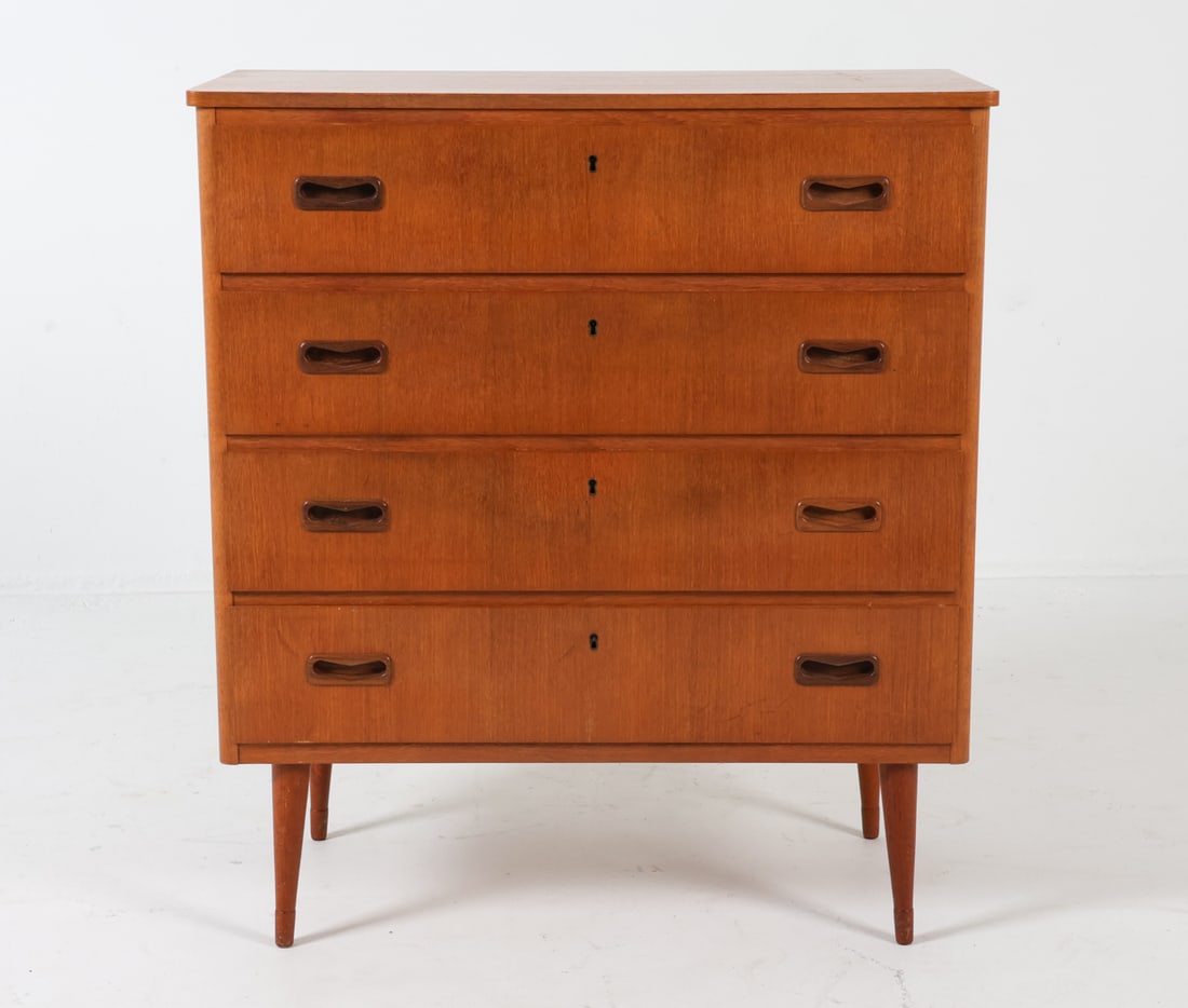 SWEDISH TEAK CHEST OF DRAWERS C. 1960S: With molded inset drawers pulls. Elegantly tapered legs. Dimensions: H 34" x W 30.25" x D 15". Condition: No key included. Subtle sun fading to top. Very few scuffs. Wear consistent with age and use. 