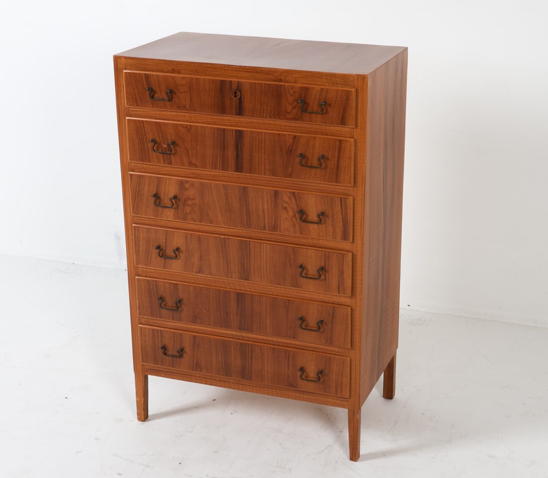 SWEDISH WALNUT CHEST OF DRAWERS C. 1960S: Brass drawer pulls. Dimensions: H 42.5" x W 27" x D 16". Condition: No key included. Few scuffs and dings to legs. Few scratches and scuffs to top, drawer fronts. Wear consistent with age and use. PL0