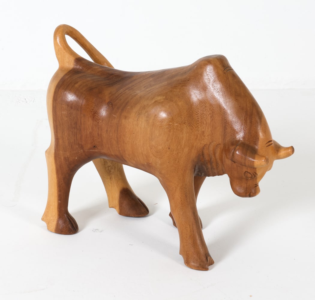 CARVED TEAK WOOD BULL FIGURE C. 1970S: Dimensions: H 15" x W 18.5" x D 7.75". Condition: Few stress cracks to wood throughout. Chip to the front hoof. Light scuffs. PL200