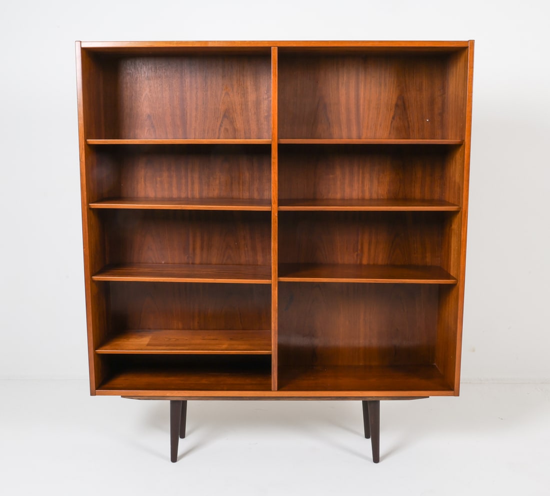 OMANN JUN STYLE DANISH ROSEWOOD BOOKCASE C. 1960S: Dimensions: H 62"x W 54" x D 12" Condition: Sides show light scattered scratches and dings. Back panel has previous repair. Proper left lower shelf has one less shelf. Wear consistent with age and use