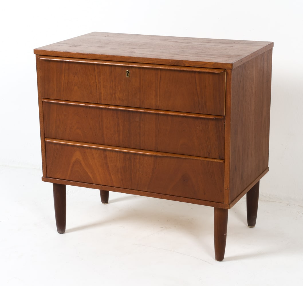 MID-CENTURY DANISH TEAK CHEST OF DRAWERS C. 1960S: Includes key. Dimensions: H 25.25" x W 26.5" x D 15.75" Condition: Surface nicks, scuffs, dings, slight damage to edges and handles, and a repaired bottom on the lower drawer.