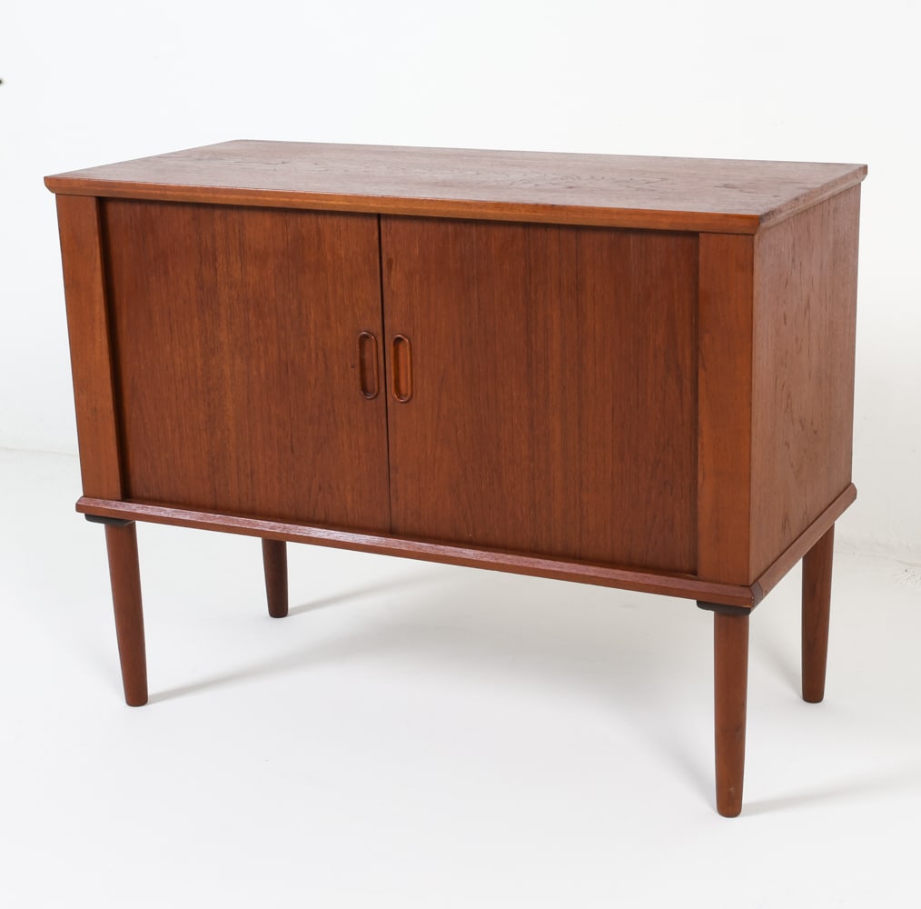 DANISH TEAK TAMBOUR DOOR CABINET C. 1960S: Features tambour doors with molded handles. Dimensions: H 25.75" x W 33.75" x D 15.75" Condition: Surface shows slight rubbing and marks. Cabinet presents well overall.