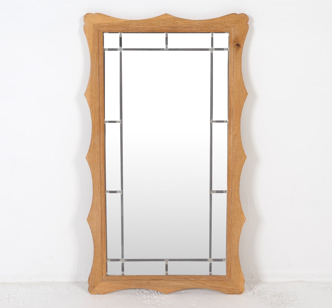 HENNING KJAERNULF STYLE DANISH OAK WALL MIRROR: Oak frame with leaded glass. In the style of Henning Kjaernulf. Dimensions: H 35.75" x W 20" Condition: Edges to frame have minor nicks and dings. Slight scuffs to glass. Wear consistent with age and