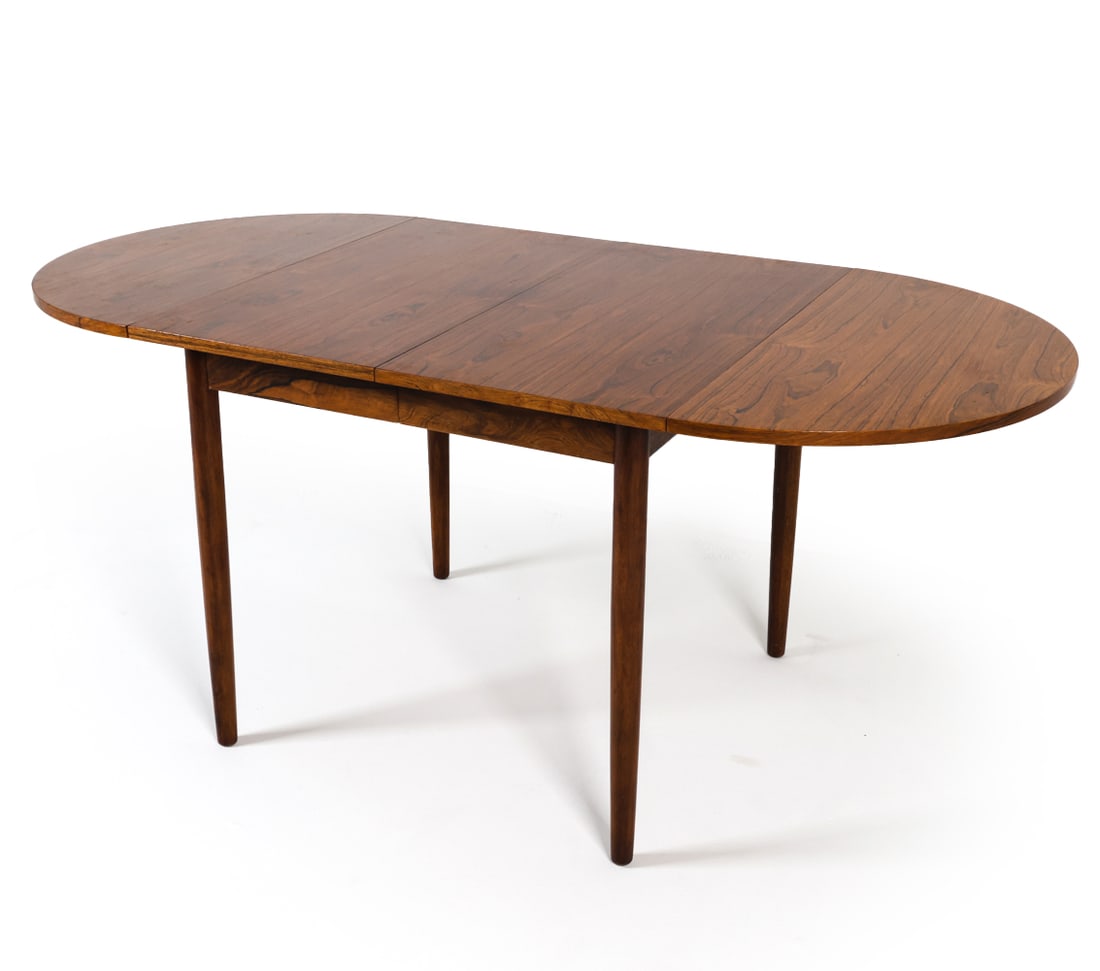ARNE VODDER STYLE ROSEWOOD EXTENDING DINING TABLE: (4) Leaves included- (2) leaves can hang down on hooks to sides or be removed. Denmark, circa 1960s. Dimensions: H 28.5" x W 33.25" x D 33". Demilune Leaf W 16.5". Center Leaves W 15.5". Full W, All L