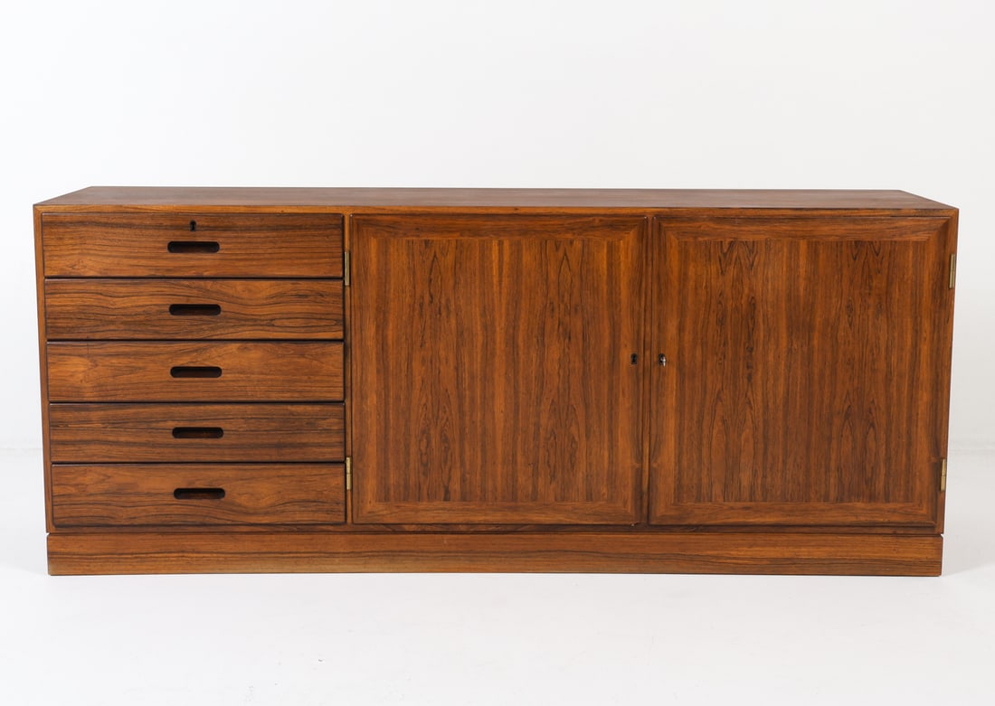KAI WINDING DANISH ROSEWOOD SIDEBOARD C. 1970S: Includes (1) key. Danish stamp on backside. Dimensions: H 26.75" x W 64.75" x D 15.75" Condition: Few scuffs and scratches to top. Wear consistent with age and use. GCD107